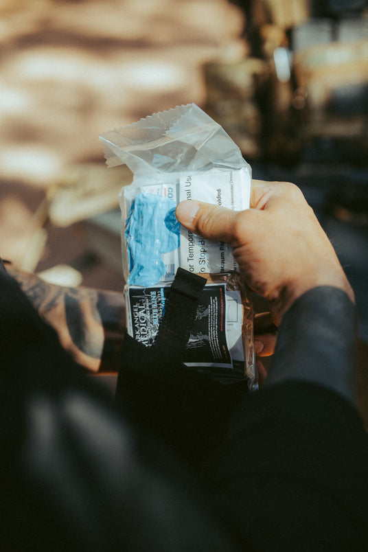 Pulling the sealed medical insert from the Blue Line trauma kit sleeve