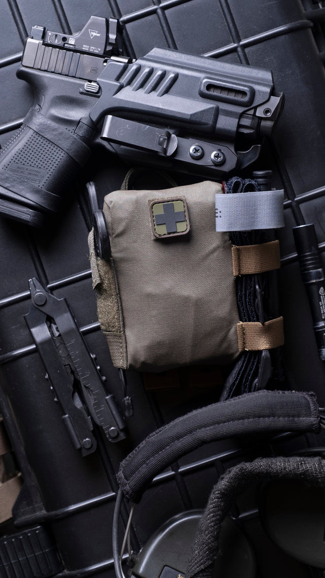 EDC Trauma Kit staged with everyday carry gear