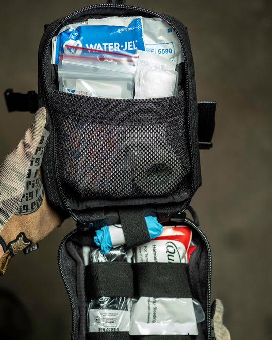 D.A.R.K. Explorer Kit open with first aid supplies in the mesh pocket