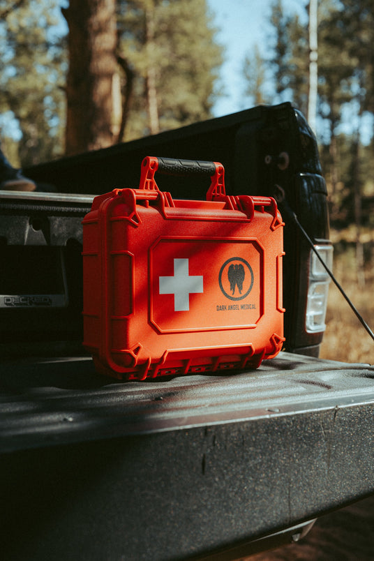 HARD Case waterproof first aid kit on a truck tailgate in the forest
