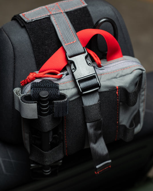 Retention buckle and pull strap detail on the HEDR headrest trauma kit