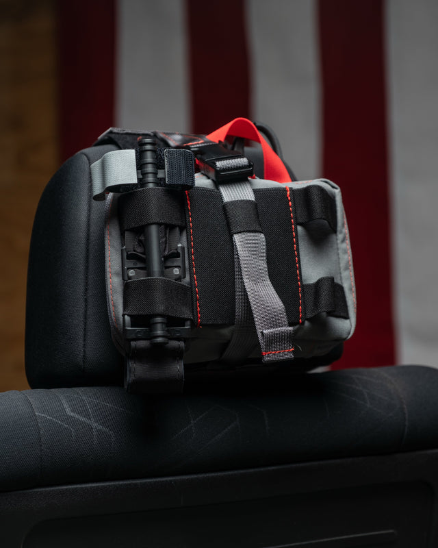 Wolf grey HEDR headrest trauma kit with an American flag backdrop
