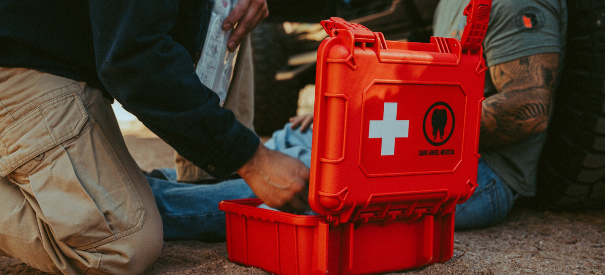 Rendering aid beside a vehicle with the Dark Angel Medical HARD Case open