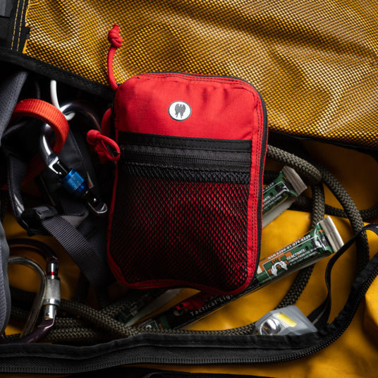 Red Ouch Pouch Plus first aid and trauma kit packed with climbing gear