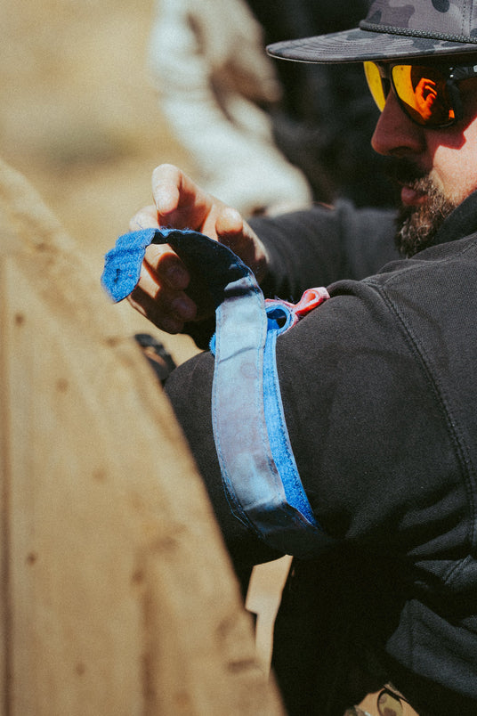 Applying a training tourniquet to a partner's arm during a class