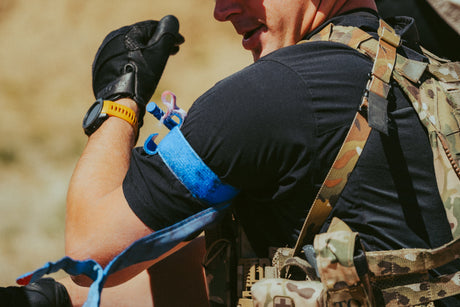 Student applying a tourniquet during Direct Action Response Training