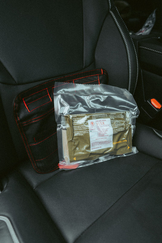 Vacuum sealed medical insert for the VISR visor trauma kit beside the panel