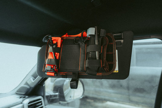 VISR trauma kit mounted to a vehicle sun visor with hook and loop straps
