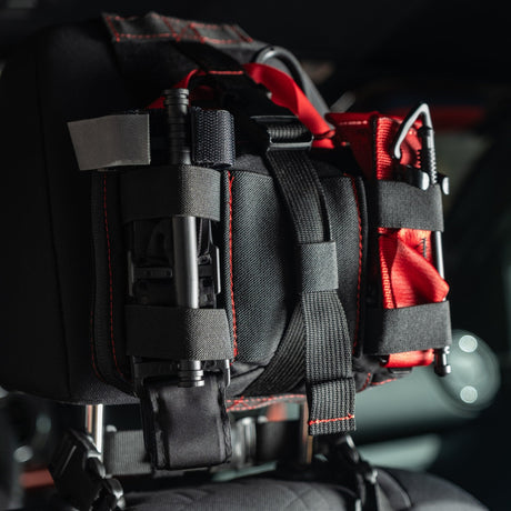 Black HEDR headrest trauma kit mounted in a vehicle