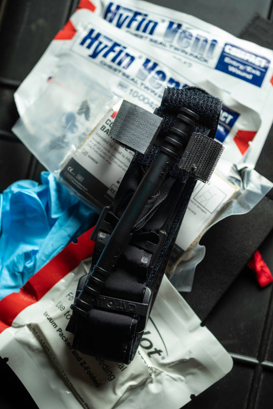 Ankle Kit trauma kit contents including Hyfin chest seals, QuikClot dressing, mini compression bandage, tourniquet, and gloves