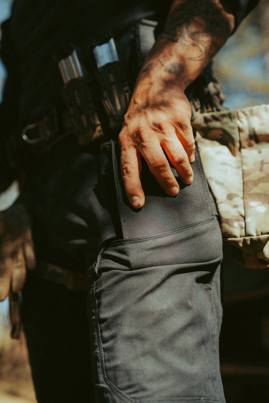Sliding the slim Blue Line trauma kit into a cargo pocket on a duty uniform