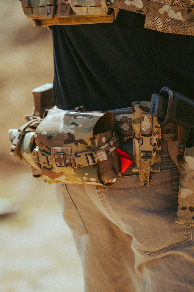 Multicam D.A.R.K. Trauma Kit mounted on a battle belt at the range