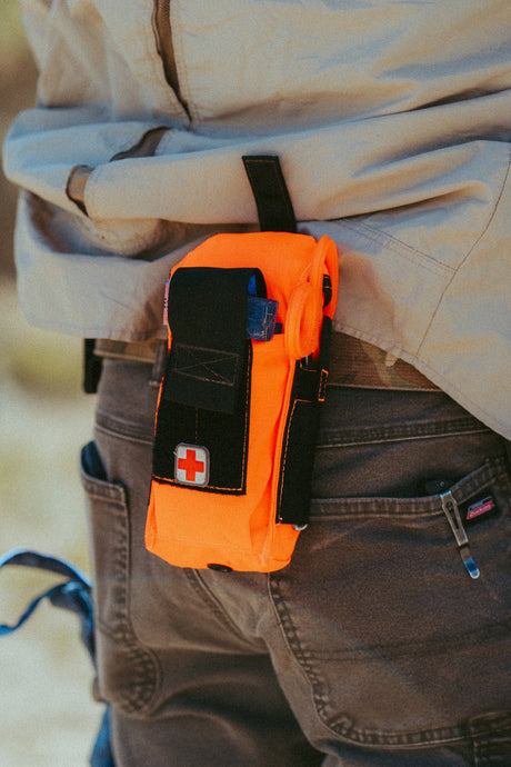 D.A.R.K. Trauma Kit in Hi-Vis Orange worn on a belt for everyday carry
