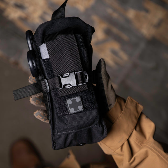 Black D.A.R.K. Trauma Kit compact enough to hold in one hand