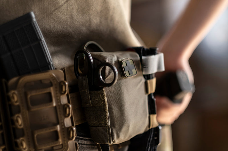 EDC Trauma Kit on a belt with tourniquet and shears in the side loops