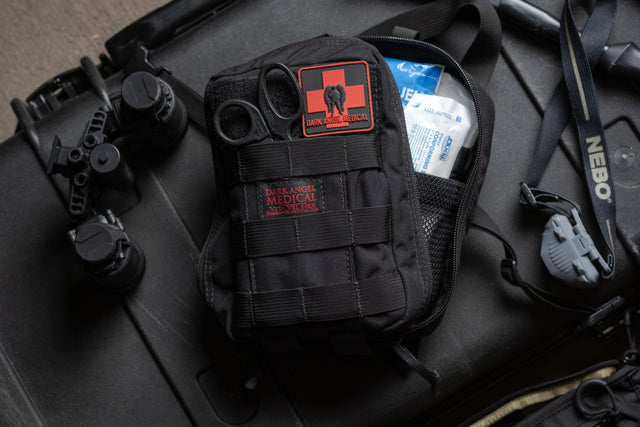 D.A.R.K. Explorer Kit staged with a flashlight on a hard case