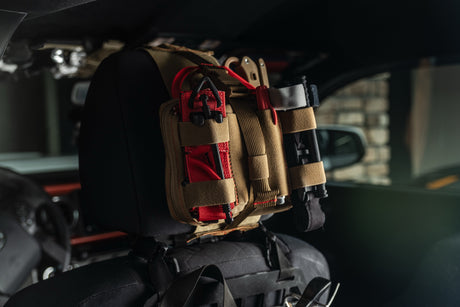 Coyote brown HEDR trauma kit mounted on a vehicle headrest