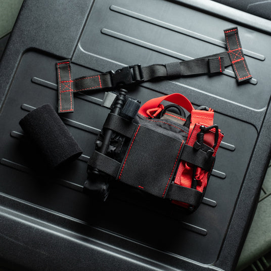 One-wrap hook and loop strap system that mounts the HEDR trauma kit to a vehicle headrest