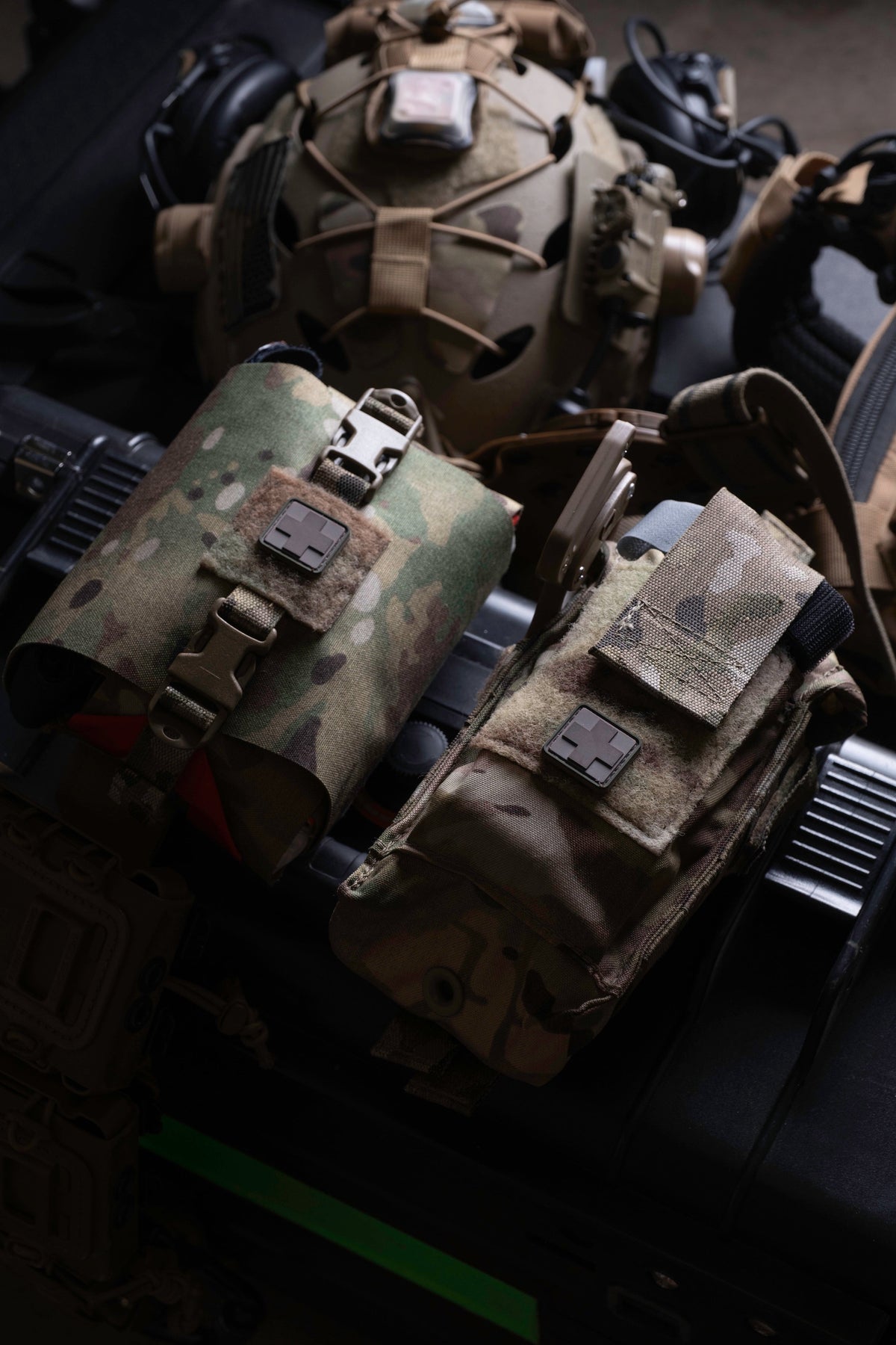 IFAK pouch mounted on a plate carrier beside a helmet