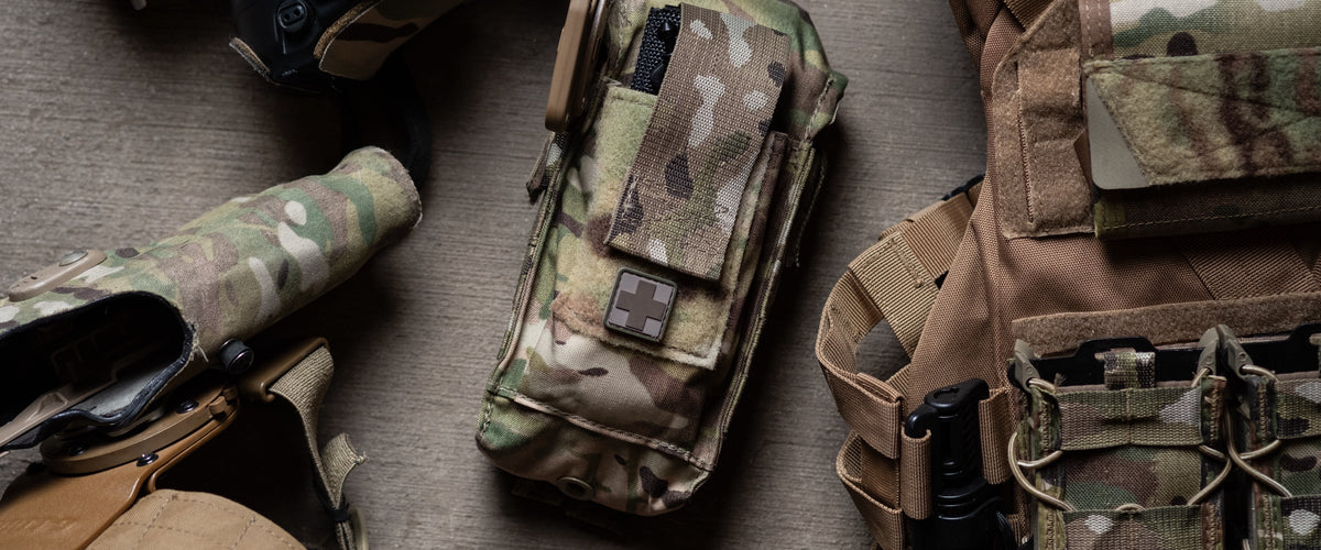 Multicam D.A.R.K. IFAK laid out with a plate carrier and holster