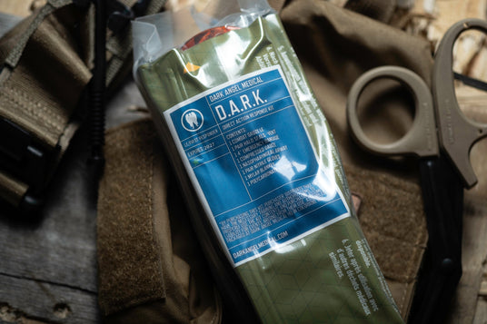 Vacuum-sealed insert and shears beside the D.A.R.K. Slim pouch