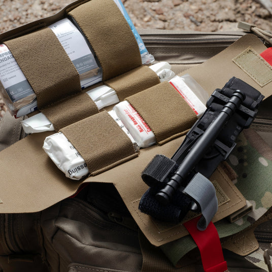 S.P.E.A.R. trauma kit opened flat showing every component staged in elastic rows