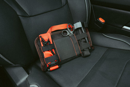 VISR visor trauma kit laid flat showing panel, tourniquet, and mini trauma shears